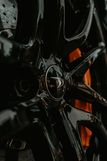 Detail of a wheel rim sparkling with freshly applied polish against a dark background