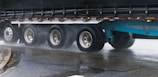 A close-up of a truck's wheel on a highway.