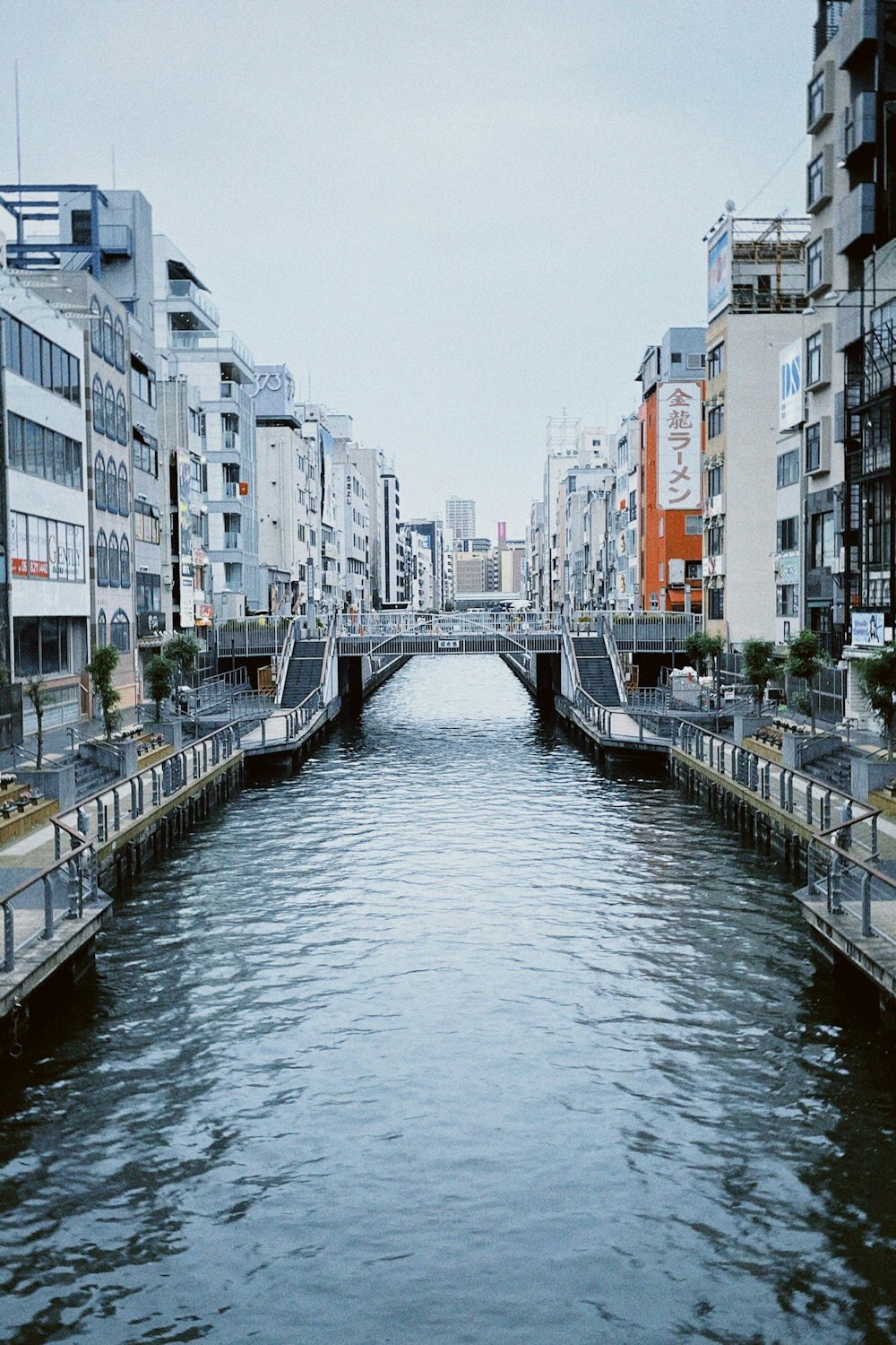 a river running through a city next to tall buildings