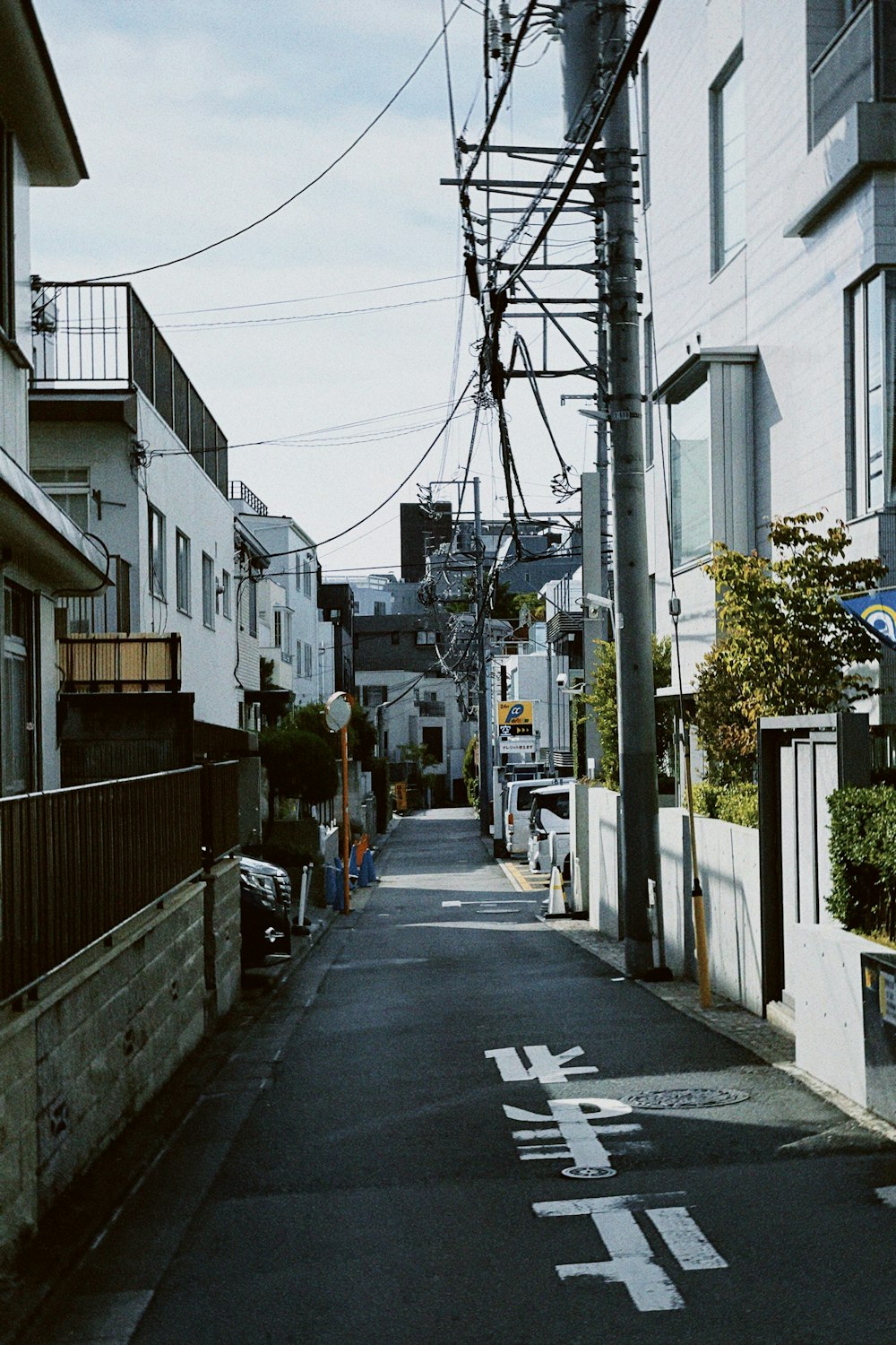 an empty street with a telephone pole above it