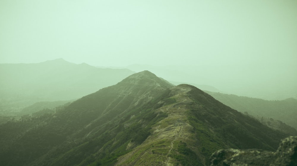 a view of a mountain range in the fog