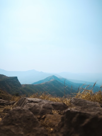 A panoramic view of rolling hills under a bright blue sky.
