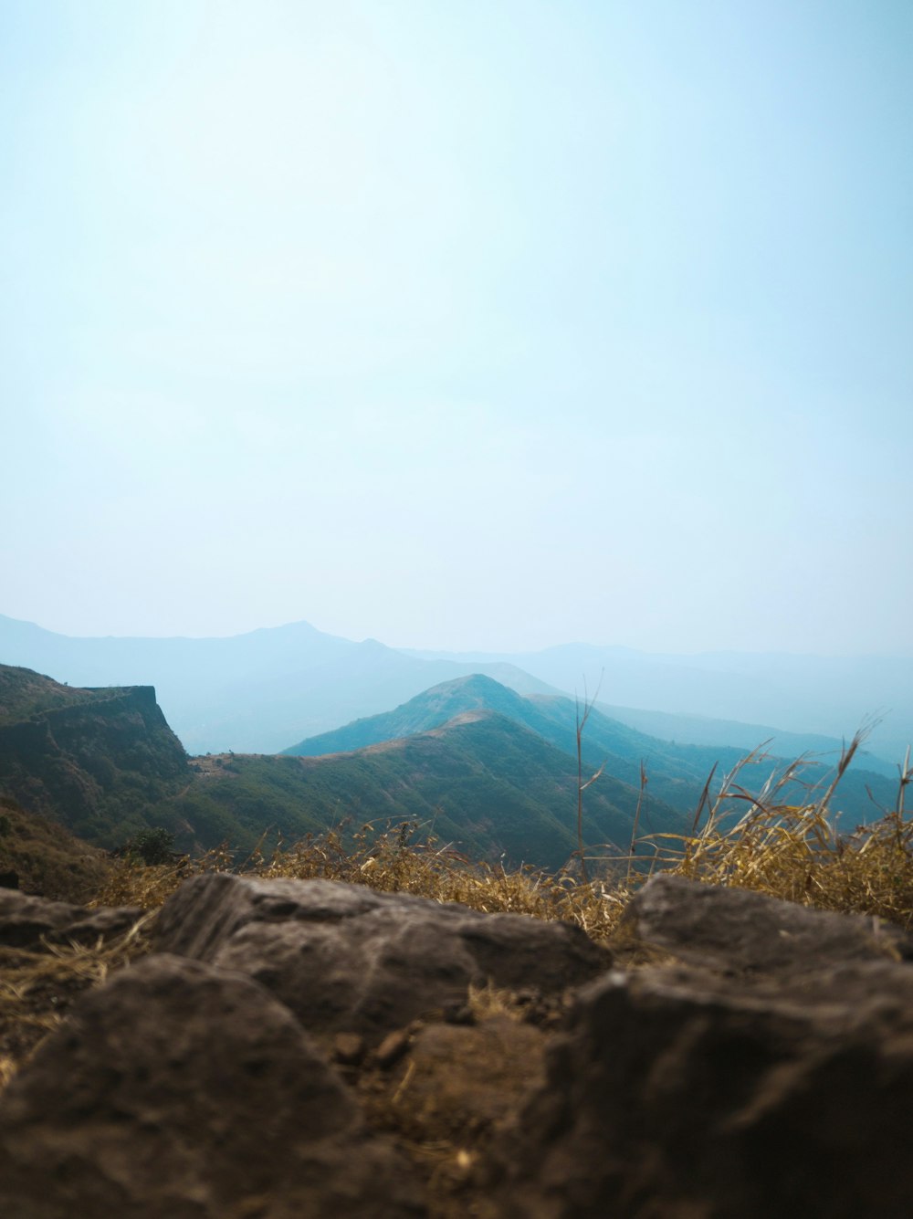 a view of a mountain range from the top of a hill