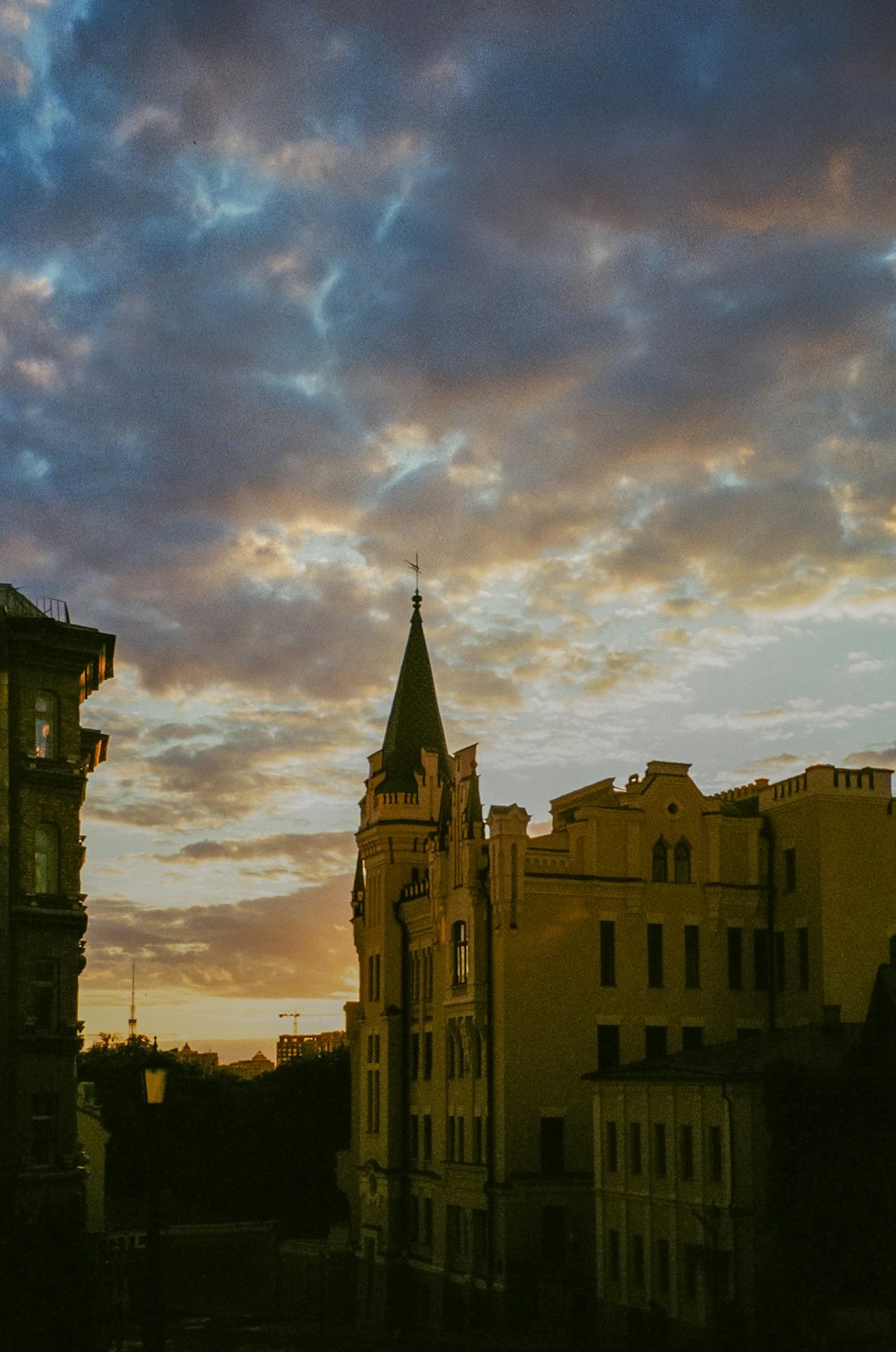 a view of a building with a clock tower at sunset