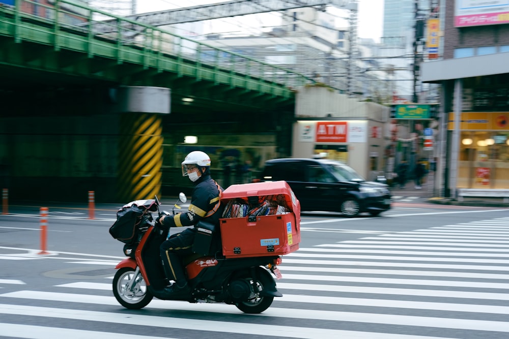 a man riding a motorcycle down a city street