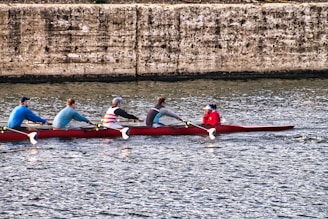 a group of people riding on top of a red boat