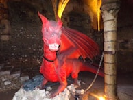 An ancient mechanical dragon winding down in a forgotten underground cavern lit by glowing crystals.