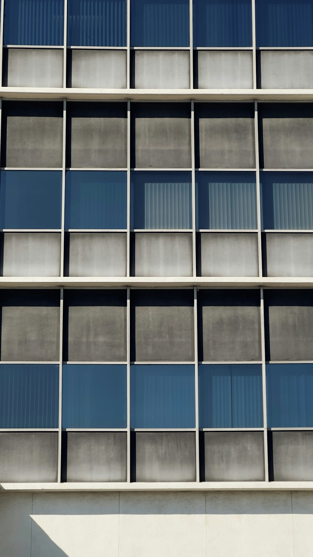 a tall building with lots of windows next to a clock