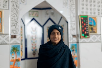 Portrait of Nazie, the main accountant, warmly greeting clients inside the Abu Snan office.