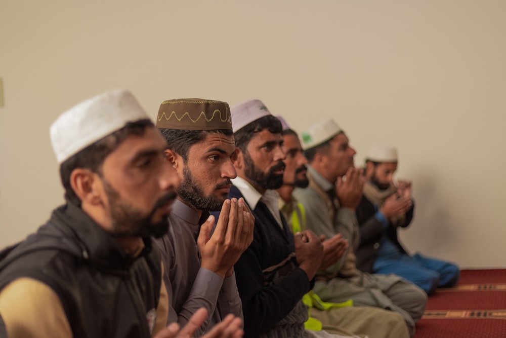 a group of men sitting next to each other