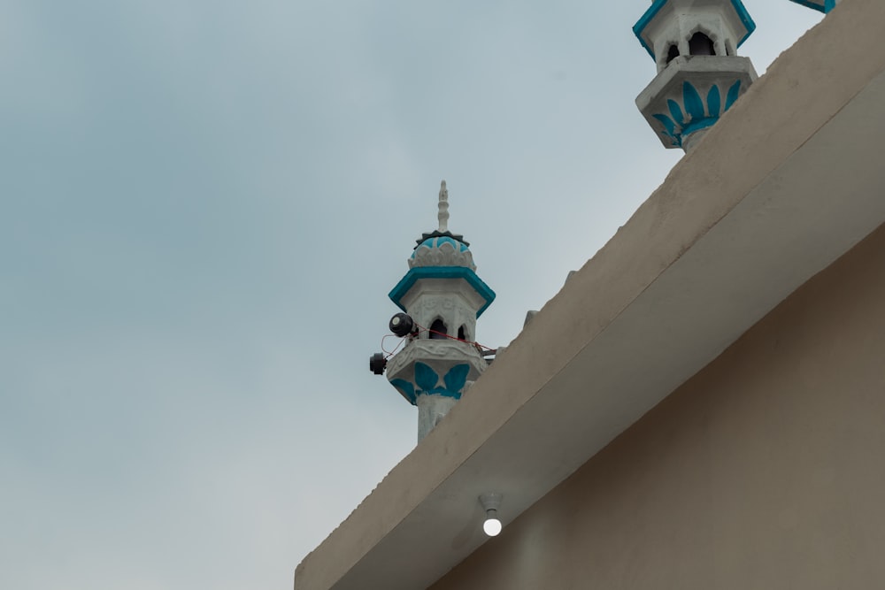 two white and blue towers against a blue sky