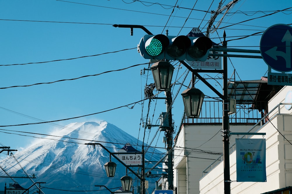 a street light with a mountain in the background