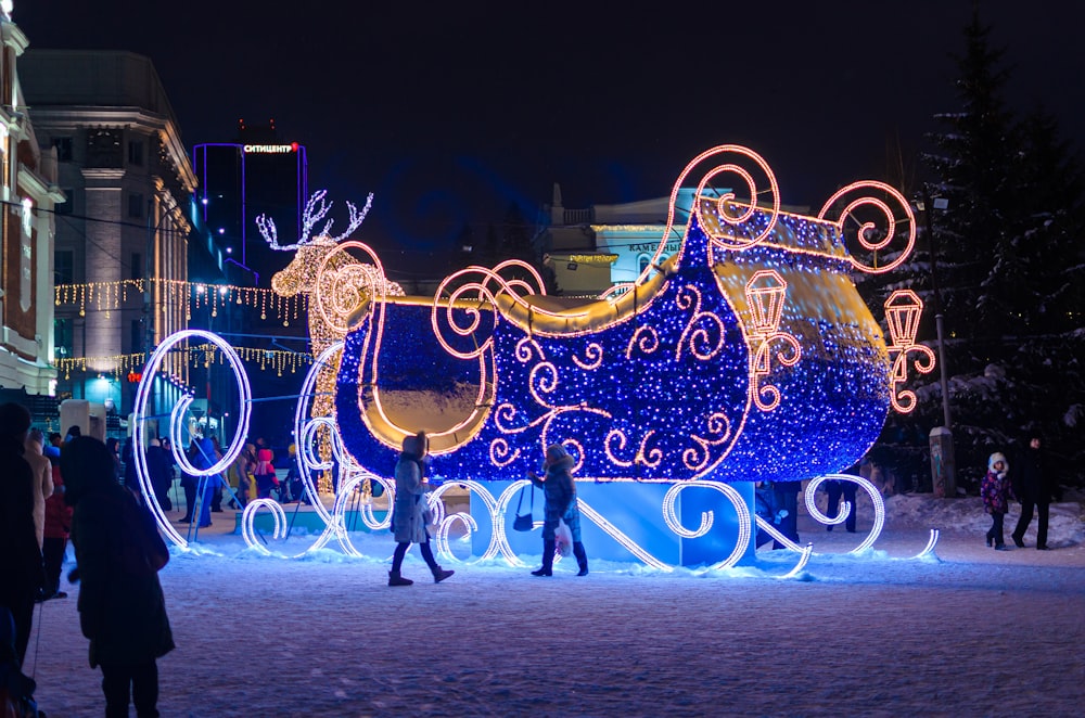 a lighted horse drawn carriage in the snow