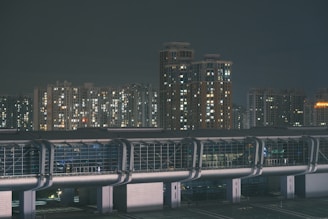 Nighttime shot of Brickell high-rise with illuminated windows against dark sky.