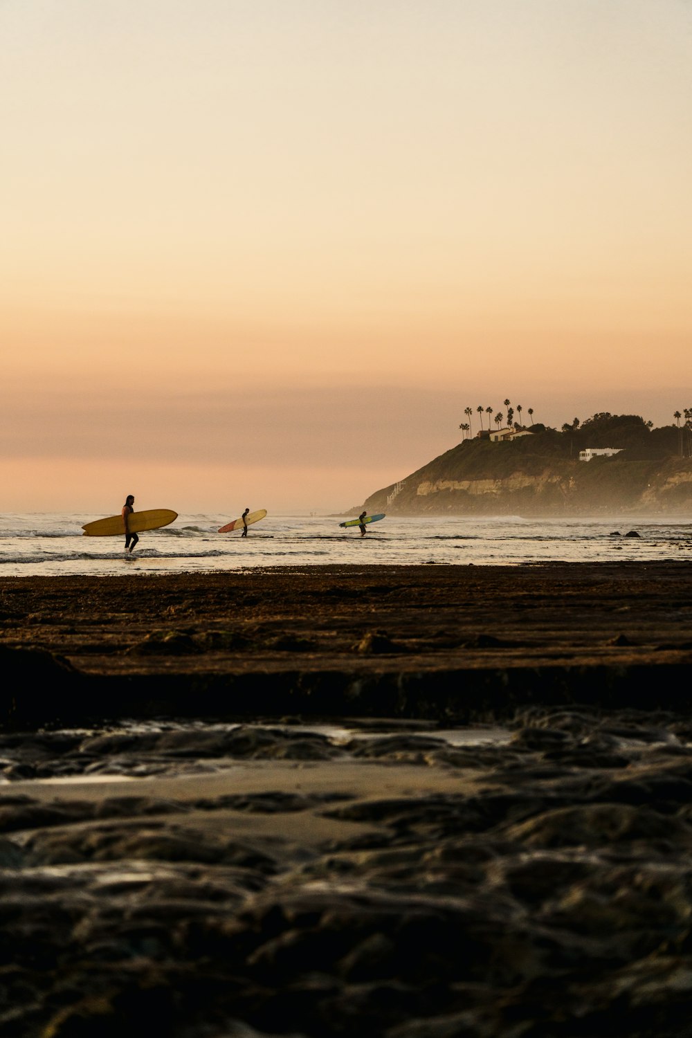 a group of people with surfboards on a beach