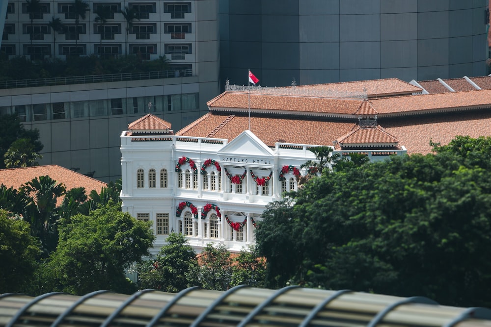 a large white building with a flag on top of it