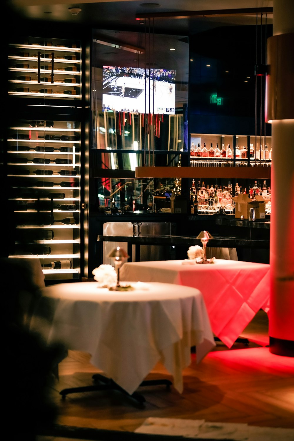 a dimly lit restaurant with two round tables