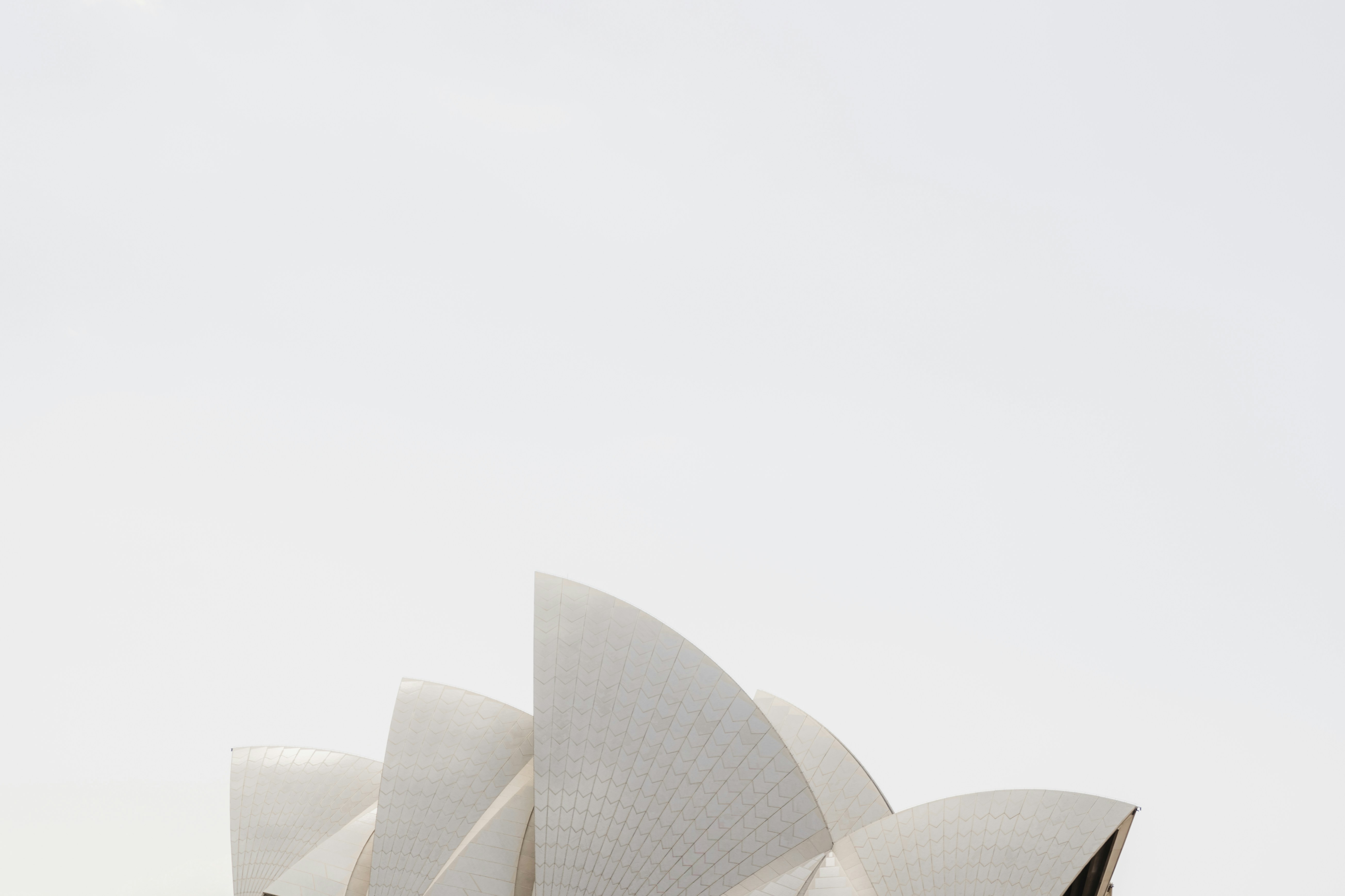 a large white building with sails on top of it