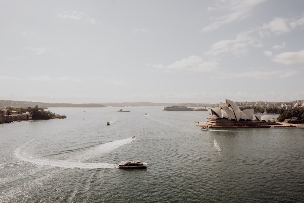 a boat traveling down a river next to a city