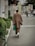A well-dressed man wearing a modern Japanese outfit in an urban setting.