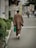 A well-dressed man wearing a modern Japanese outfit in an urban setting.