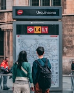 A couple navigating Qingdao’s tram system with a city map.