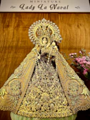 Hand-painted ceramic statue of a saint with intricate details.