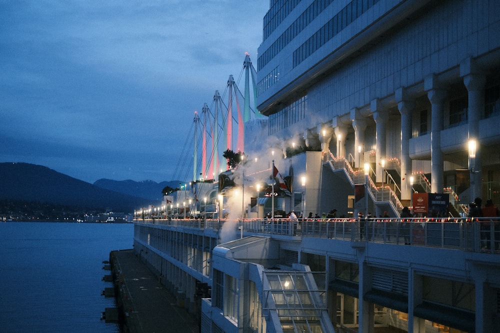 a cruise ship docked at night with its lights on