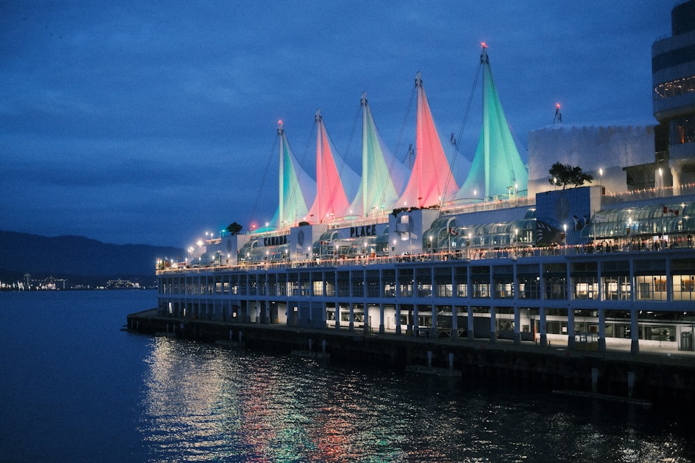 a pier that has a bunch of colorful umbrellas on it