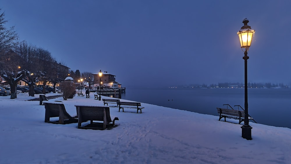 a street light sitting on top of a snow covered ground