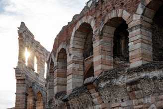 the sun shines through the windows of an old brick building