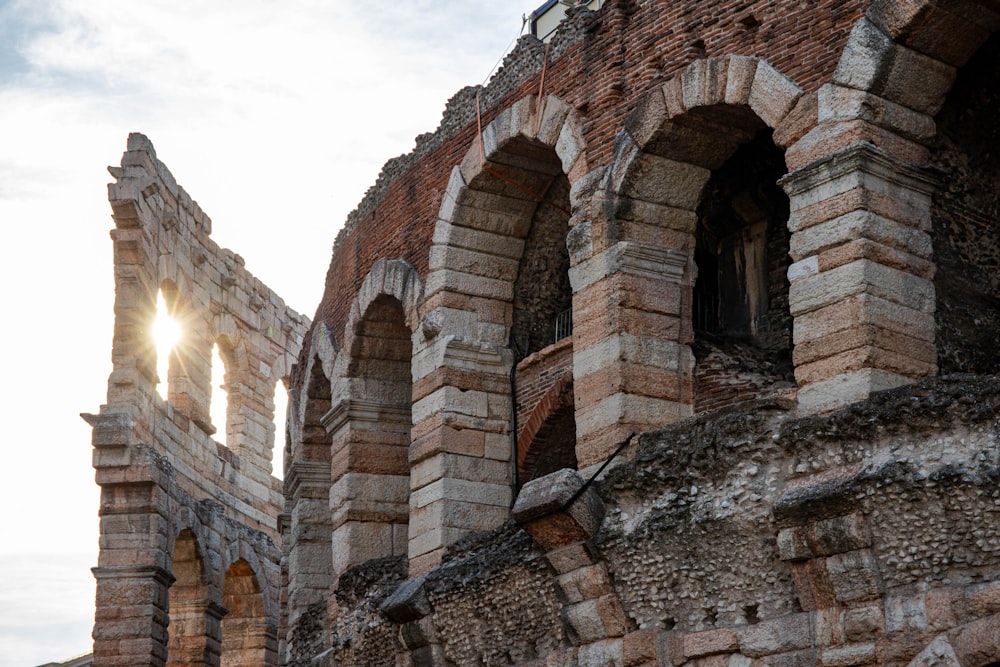 the sun shines through the windows of an old brick building