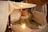 A child happily playing inside a cozy tuki tuki fort in a bright, minimalist room.