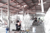 Craftspersons engaged in a creative workshop.