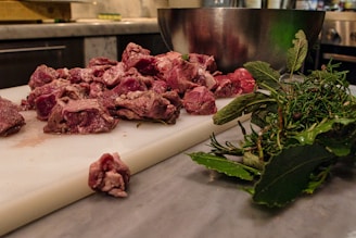 A cozy kitchen corner with fresh raw dog food ingredients neatly arranged on a wooden table.