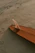 a wooden surfboard laying on the sand at the beach