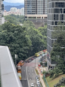 a city street filled with lots of traffic next to tall buildings