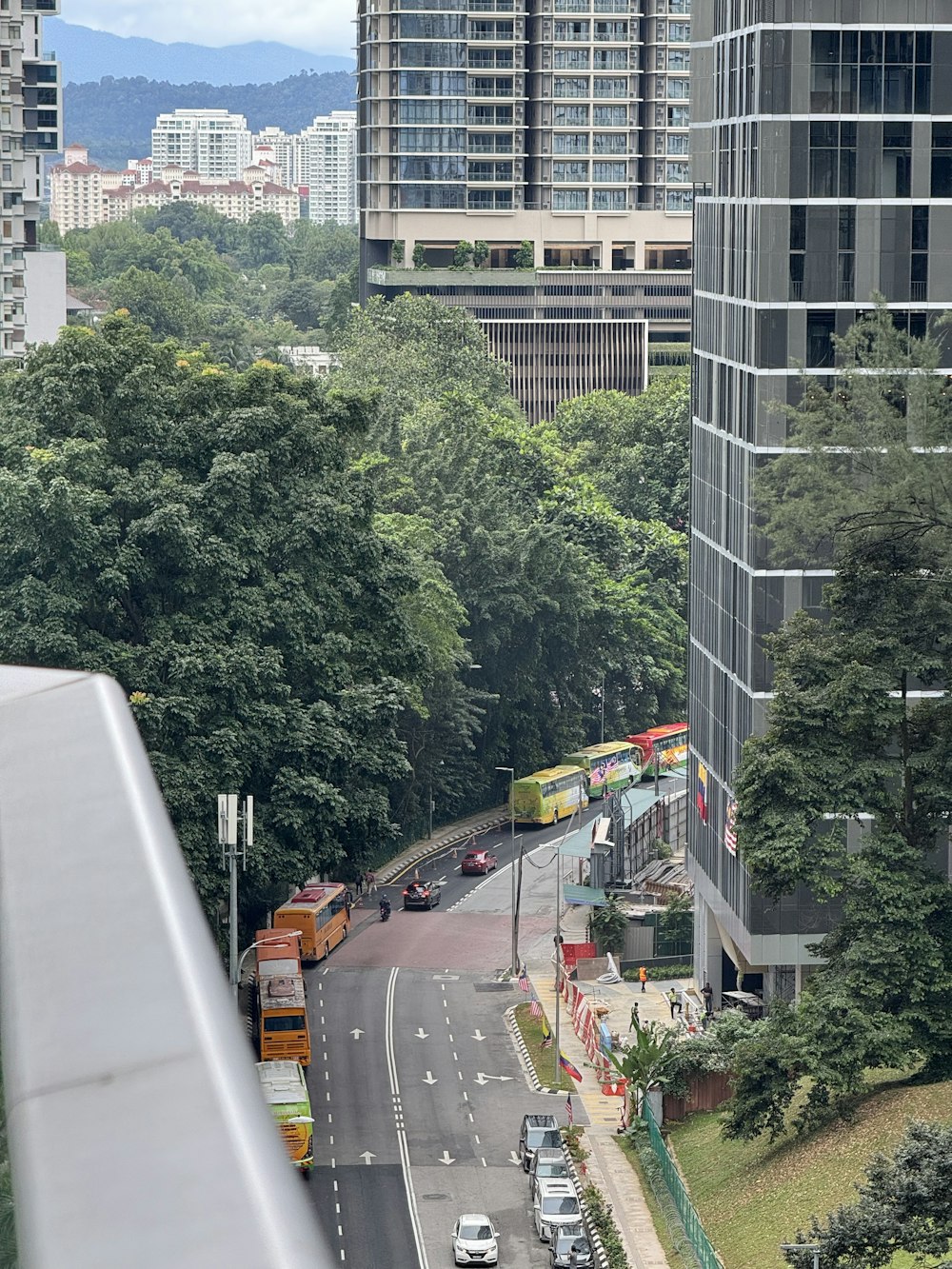 a city street filled with lots of traffic next to tall buildings