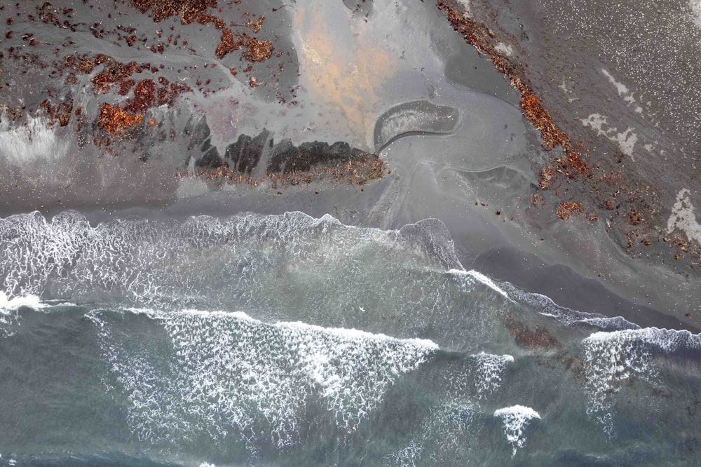 an aerial view of the ocean and land