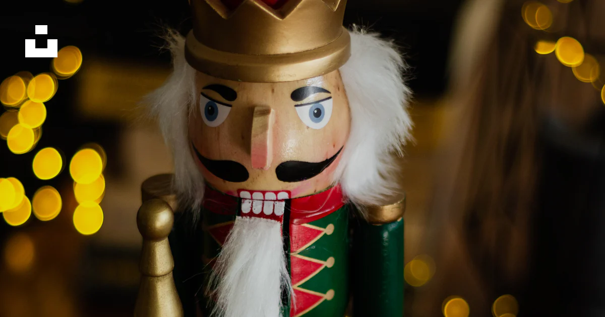 Bnutcracker A nutcracker is standing next to a candle photo – Free Nutcracker Image ...