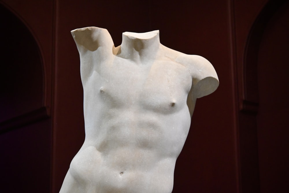 a white statue of a man with no shirt on