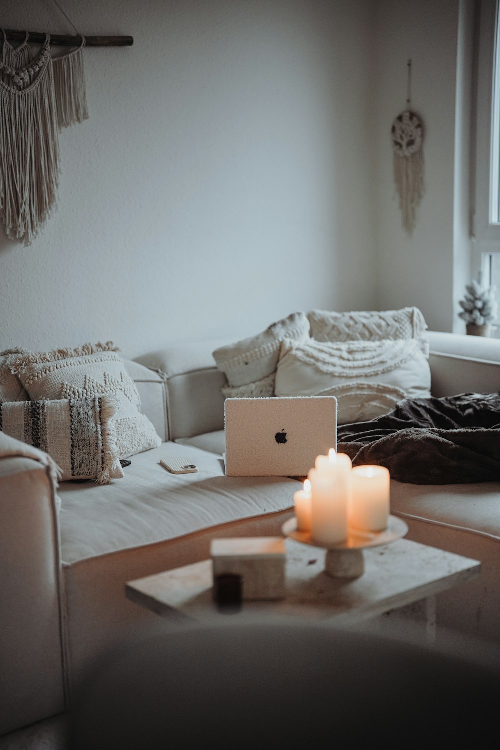 a living room filled with furniture and a laptop computer