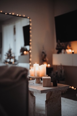 a lit candle on a table in a living room