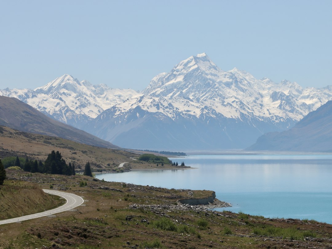 a scenic view of a mountain range with a lake in the foreground, Mount cook🇳🇿