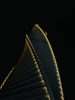 A sleek skyscraper with vertical lines glowing under a twilight sky, symbolizing modern luxury.