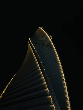 A sleek, modern skyscraper silhouette against a twilight sky, symbolizing strength and opportunity.