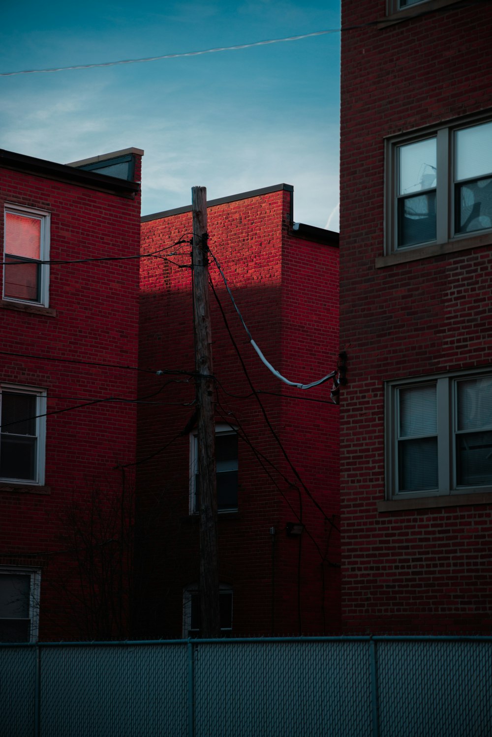 a telephone pole in front of a red brick building