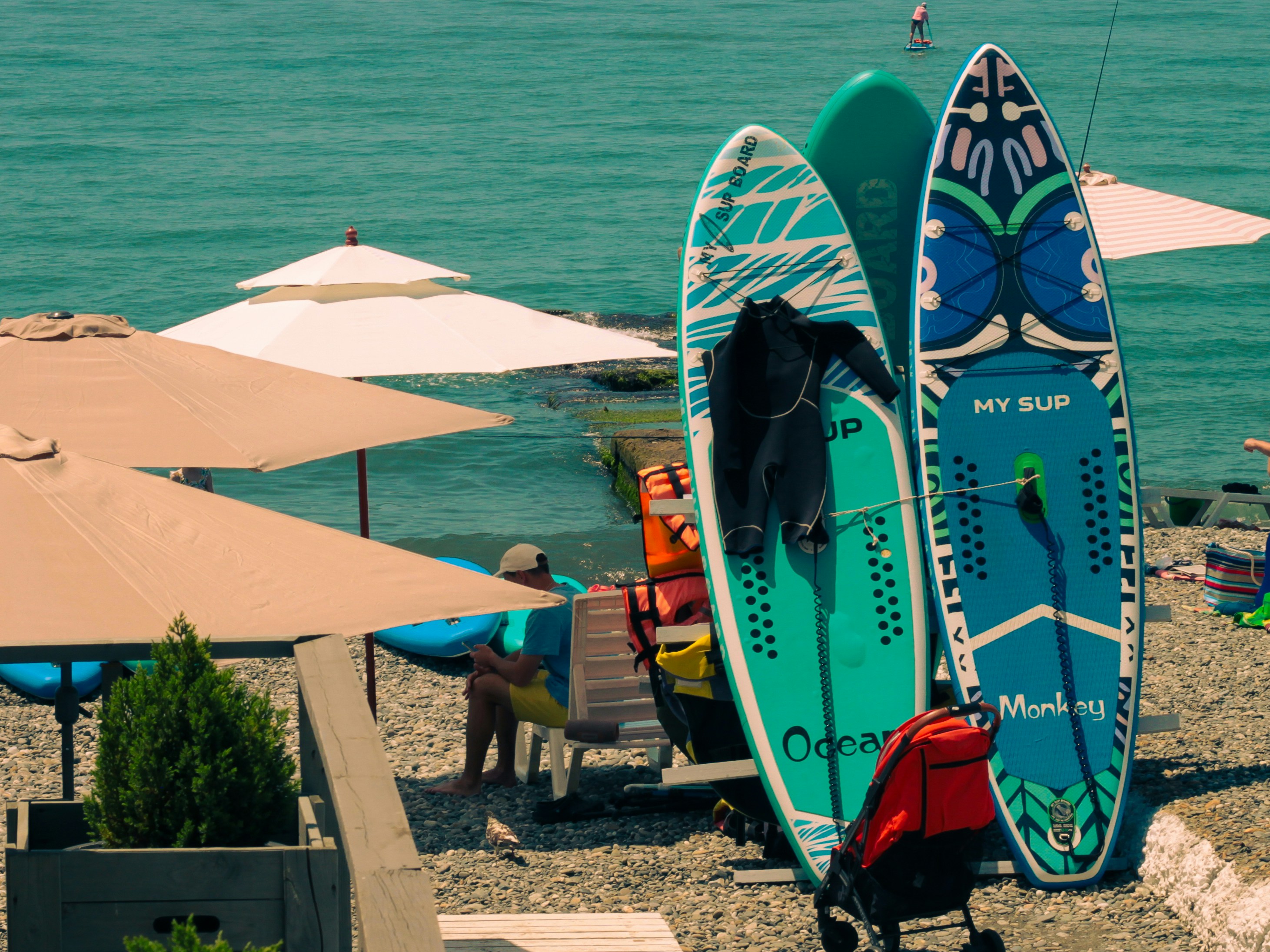 a couple of surfboards sitting on top of a beach
