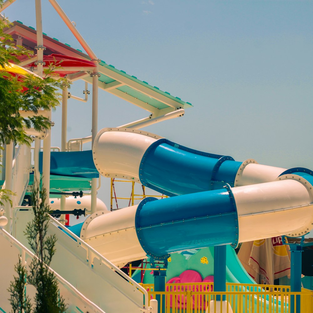 a blue and white water slide in a water park