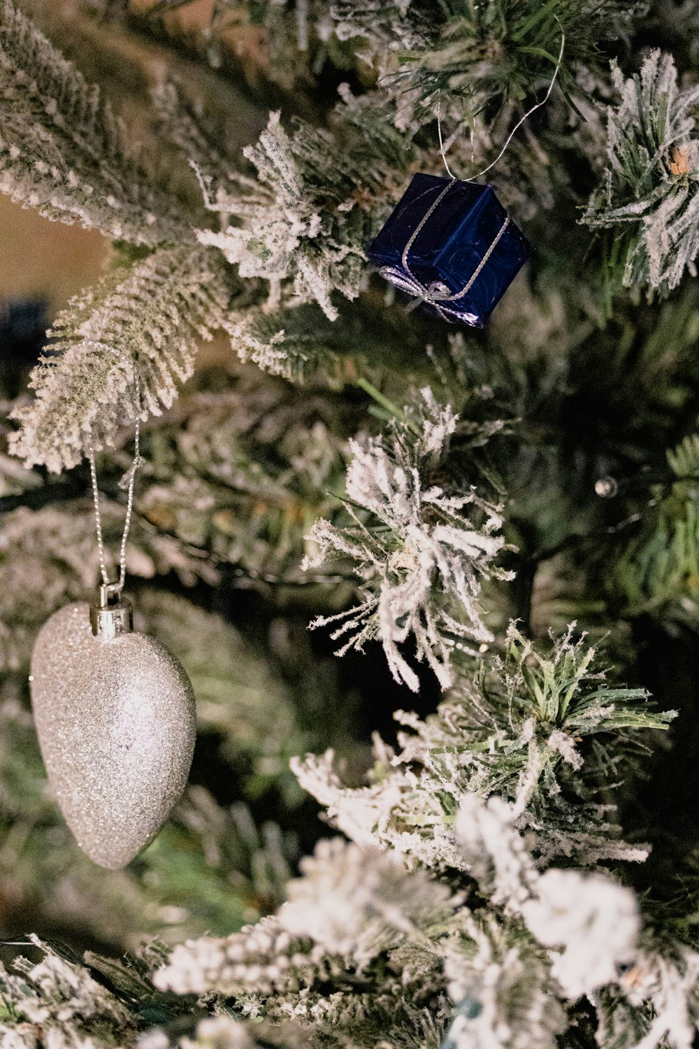 a close up of a christmas tree with ornaments on it